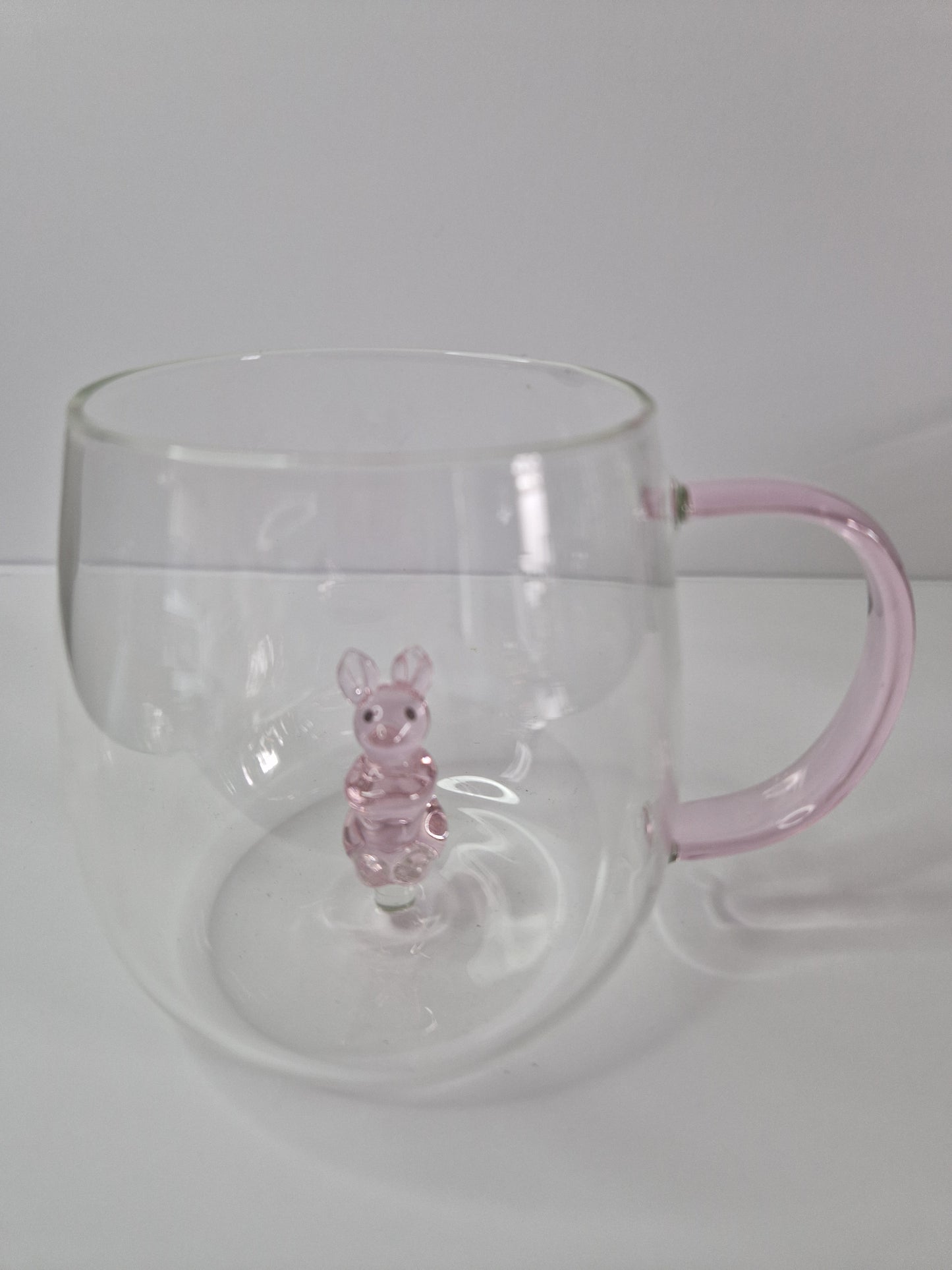 Glass coffee mugs with glass animals inside