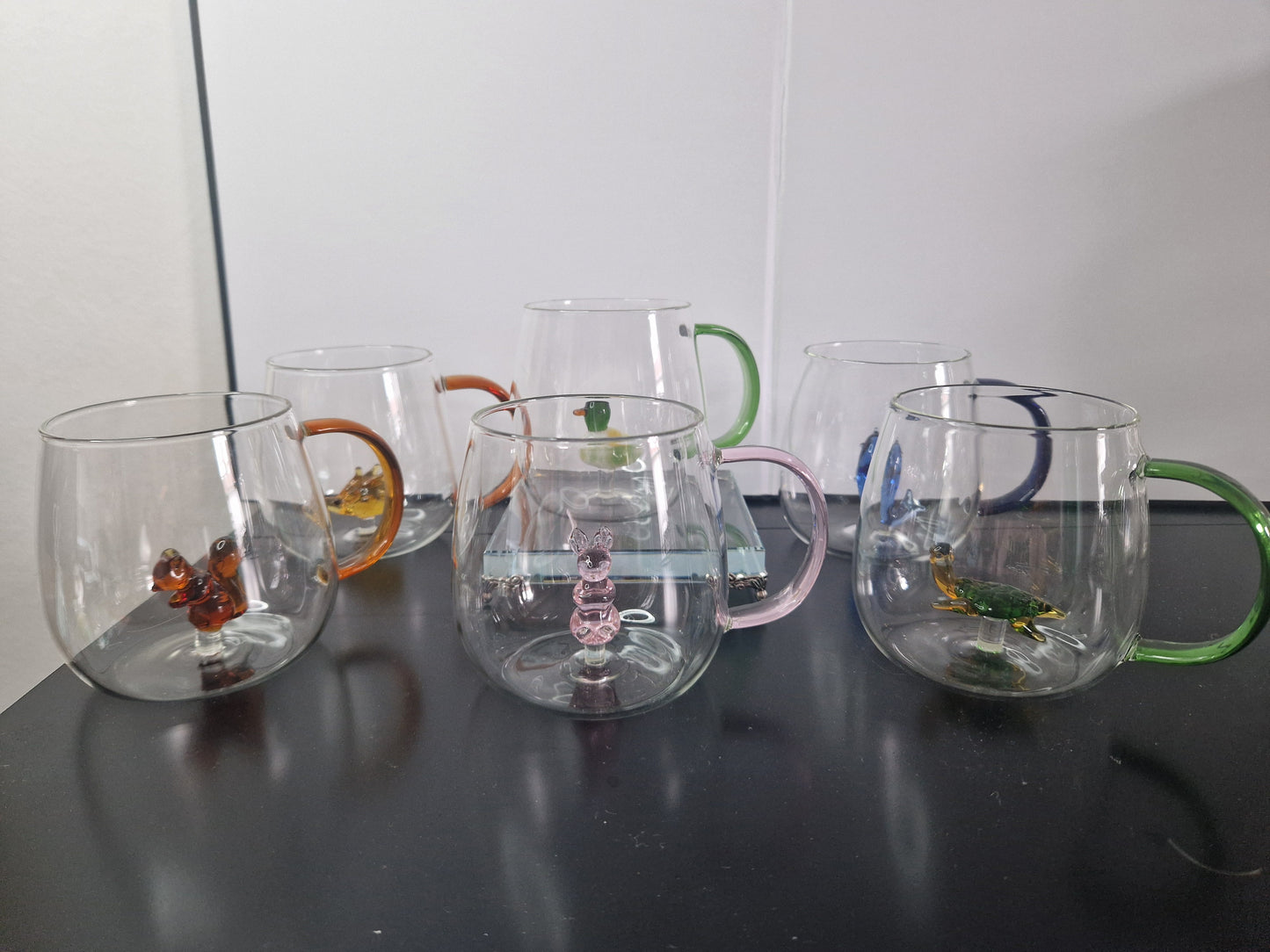 Glass coffee mugs with glass animals inside
