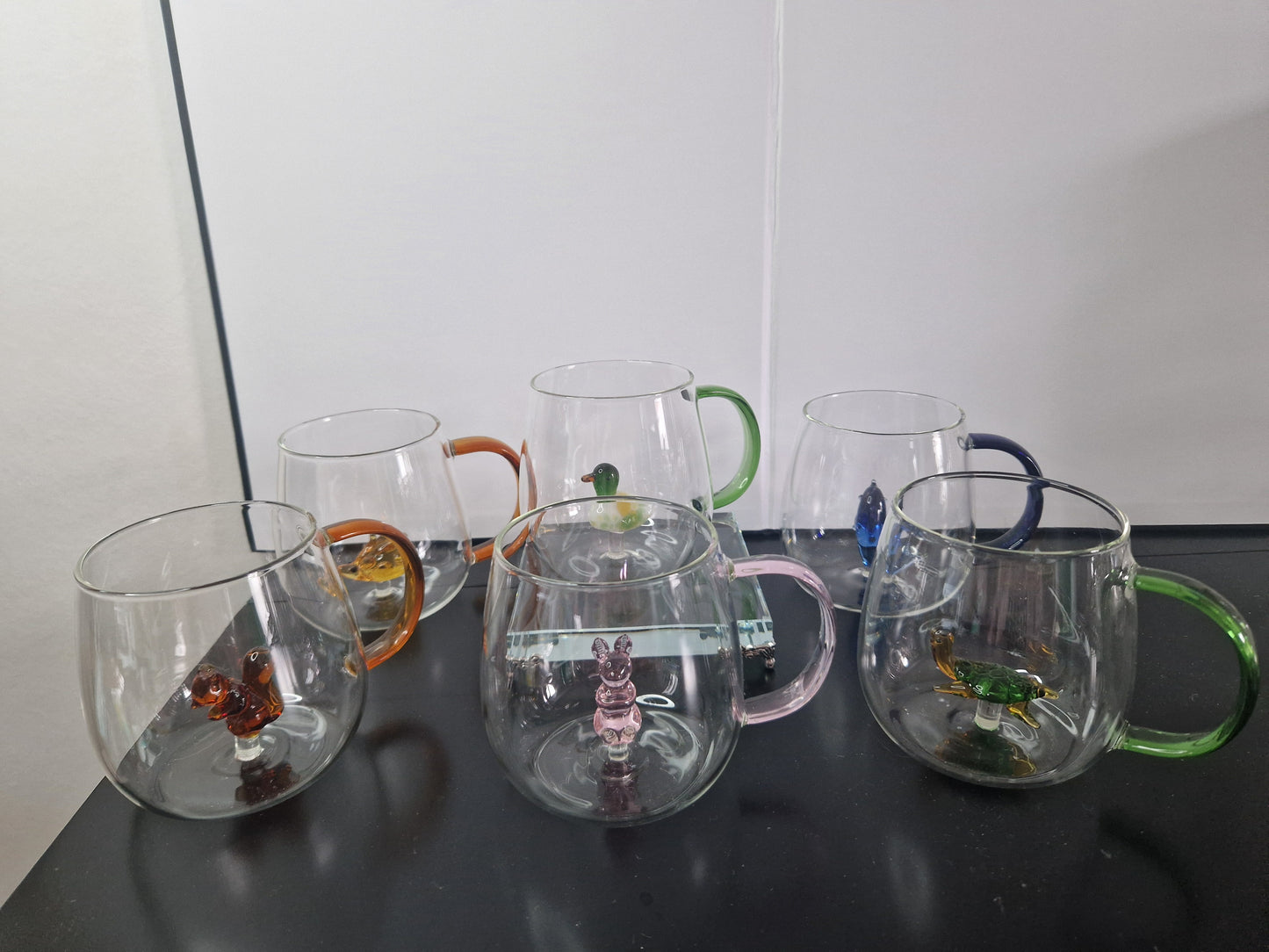 Glass coffee mugs with glass animals inside
