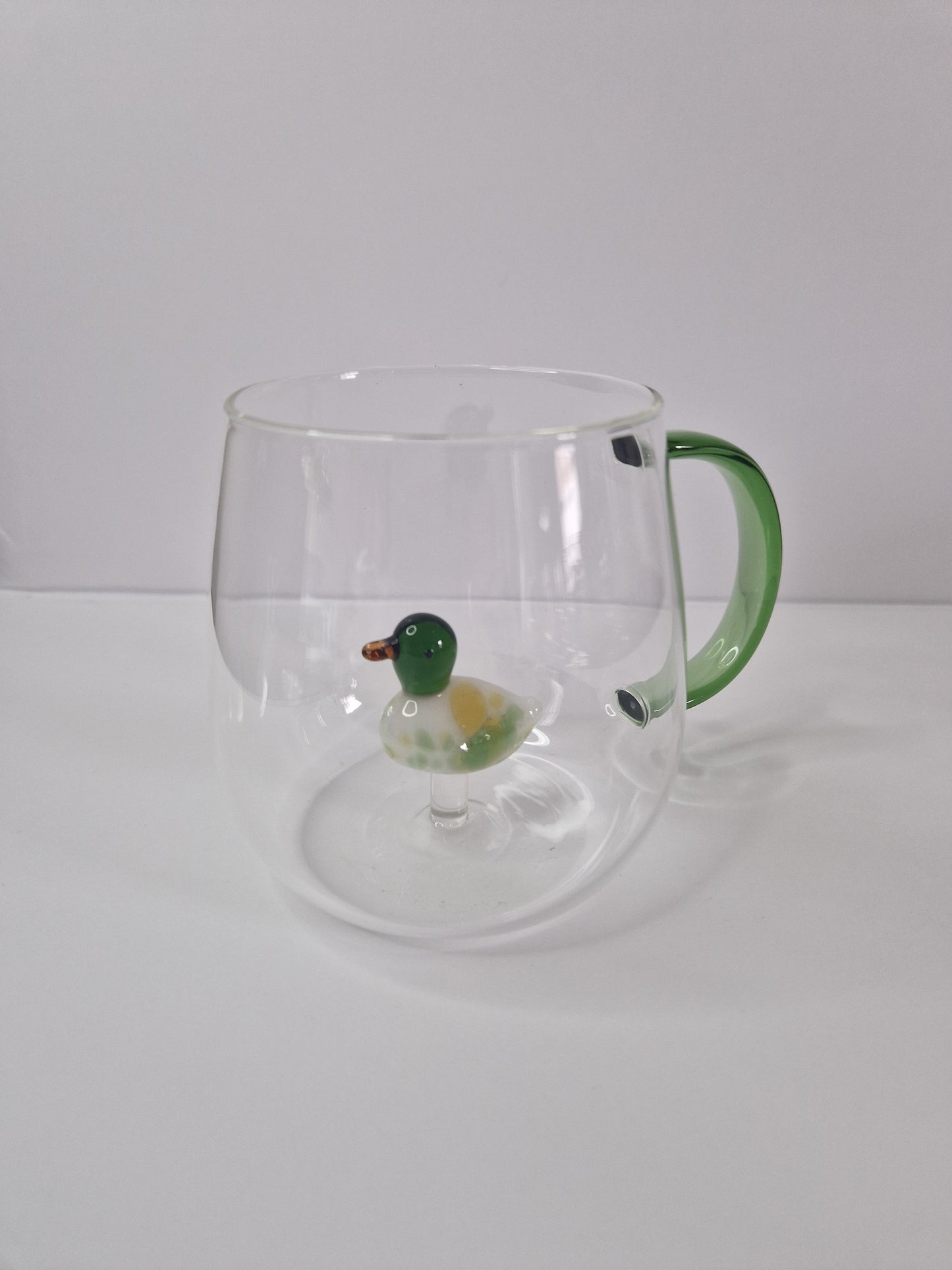 Glass coffee mugs with glass animals inside