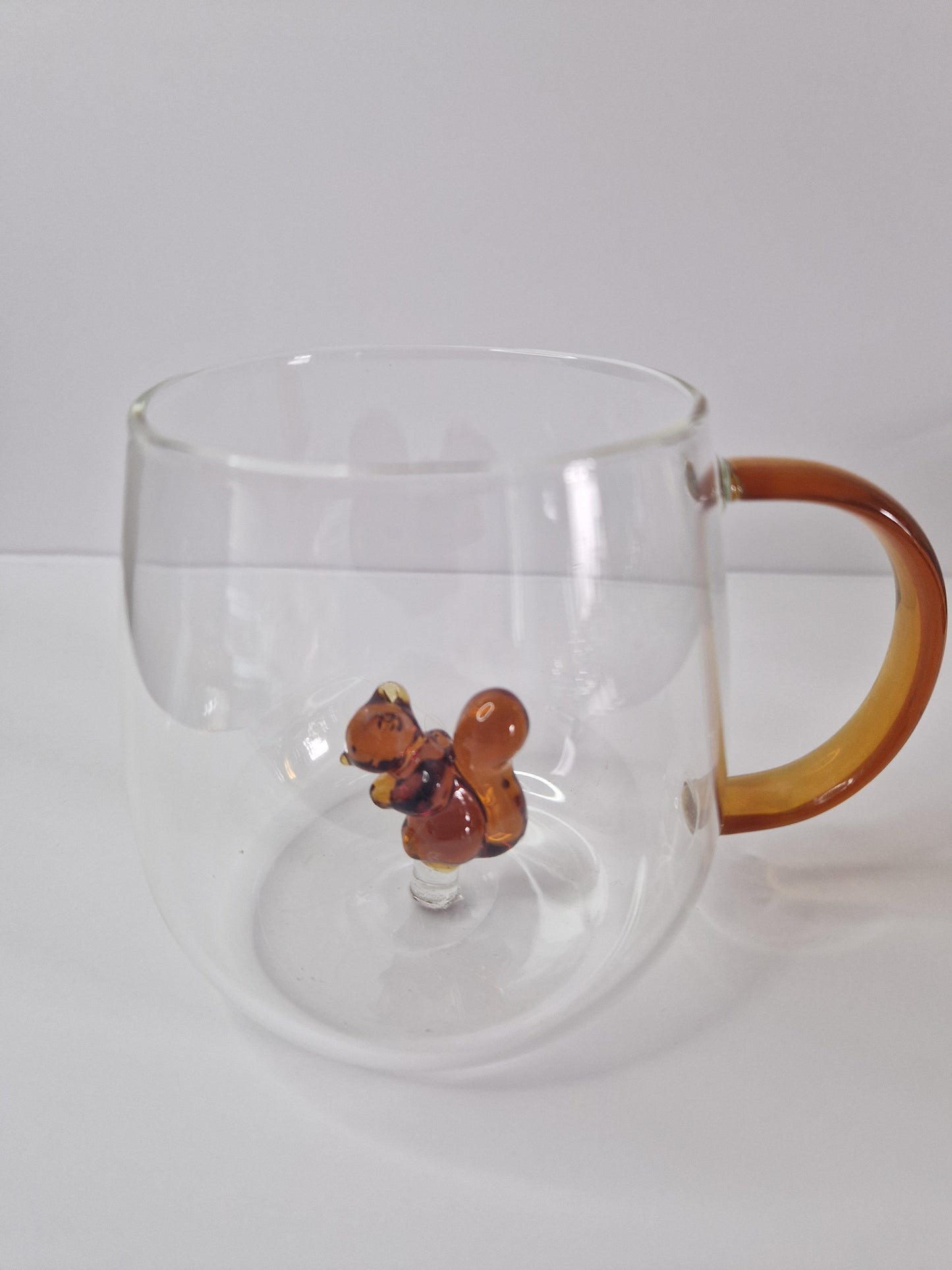 Glass coffee mugs with glass animals inside