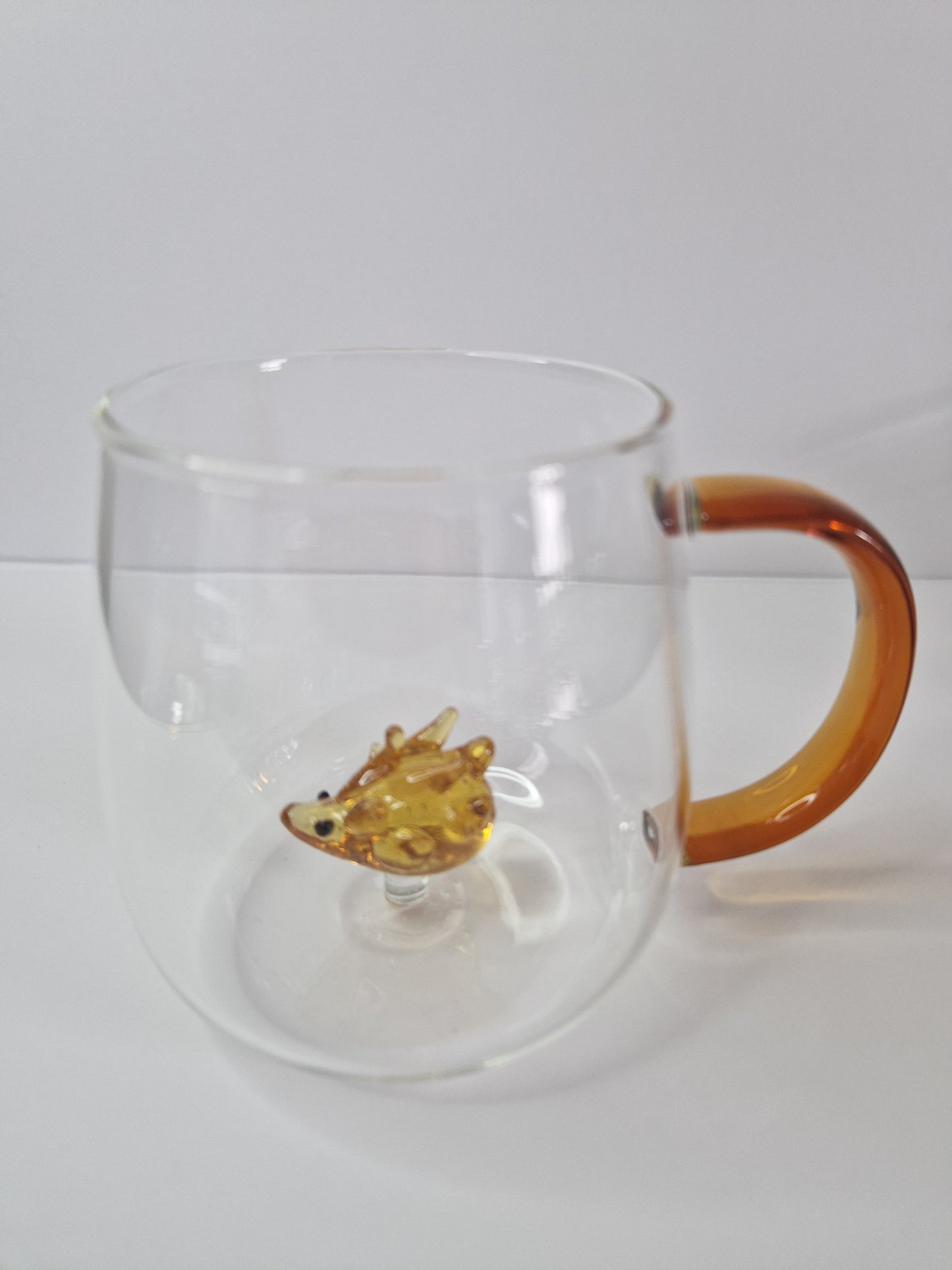 Glass coffee mugs with glass animals inside