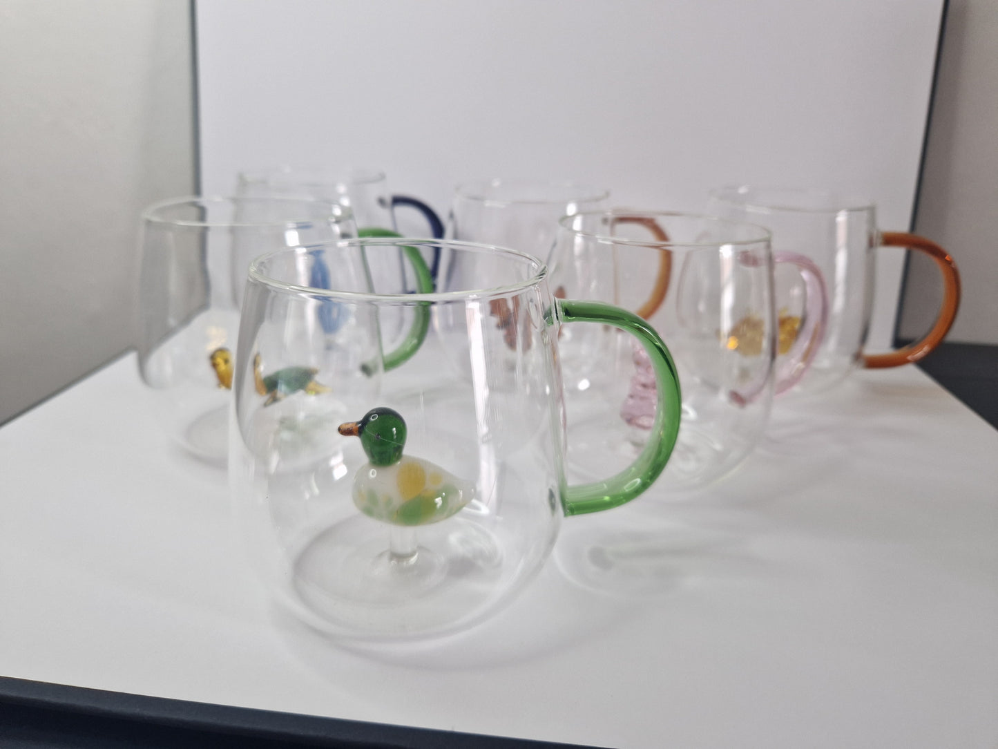 Glass coffee mugs with glass animals inside