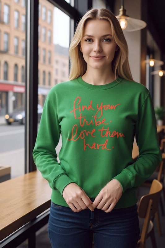 Woman wearing a green sweatshirt with red text in an urban setting