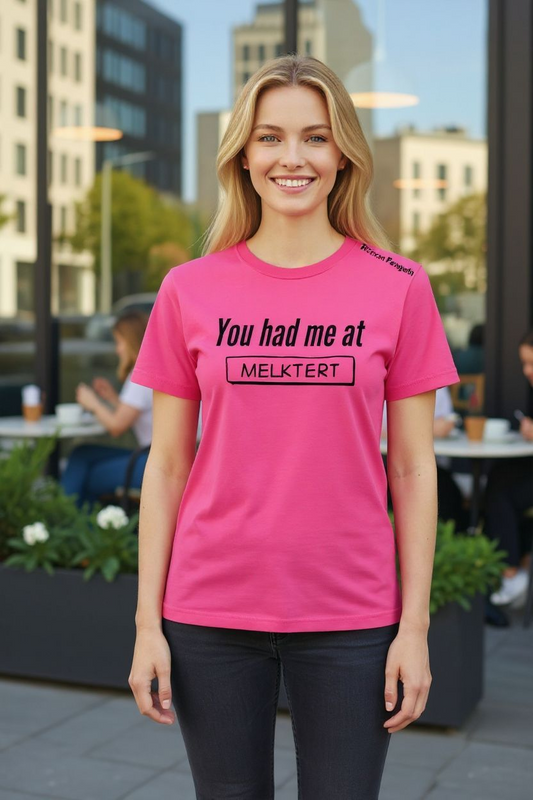 Woman wearing a pink t-shirt with text in an urban setting