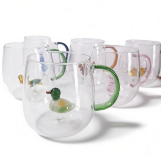 Glass coffee mugs with glass animals inside
